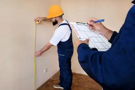 建筑工人正在施工现场用卷尺测量窗户.房屋装修概念.