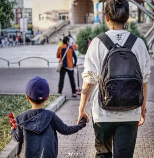 靳东妻子晒两娃背影照小儿子戴帽子呆萌可爱