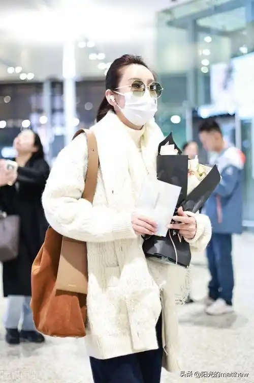 街拍:秦海璐白色毛衣开衫 牛仔裤 麂皮单肩包 墨镜温暖时髦_上海_机场