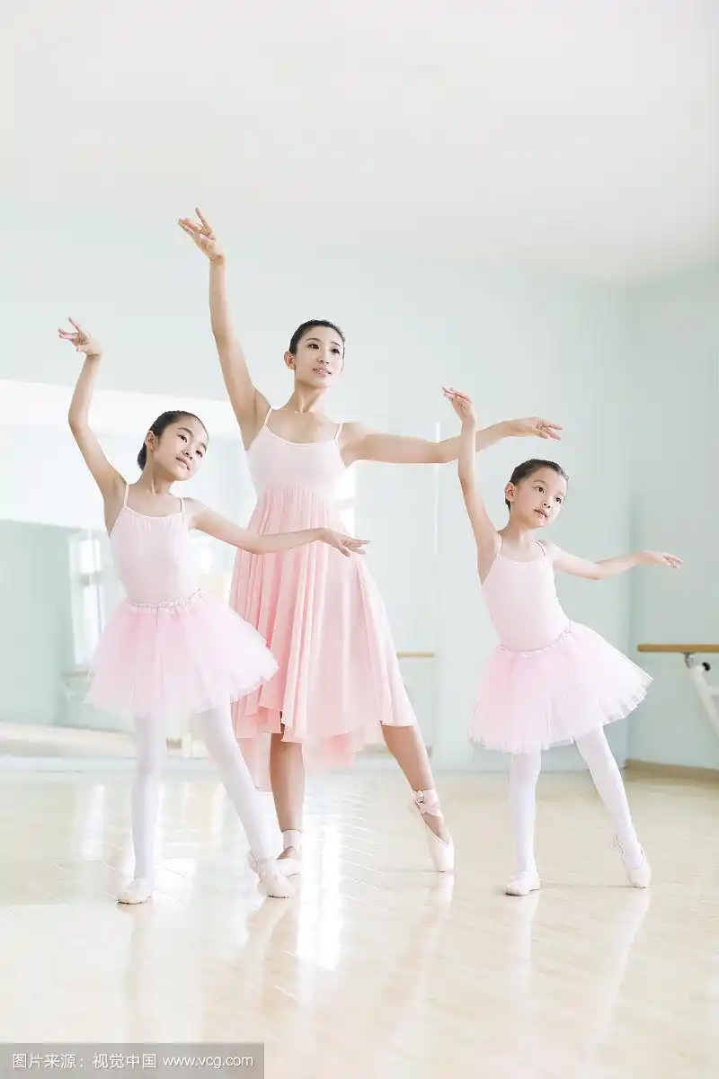 年轻舞蹈老师教小女孩们跳芭蕾