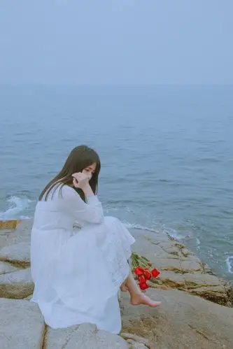 海边礁石上赤脚美女白裙唯美清纯写真图片
