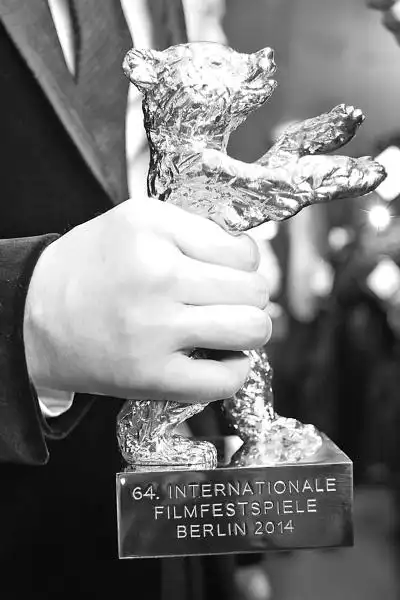 2月15日,在德国柏林,影片《白日焰火》导演刁亦男手持的"金熊奖"奖