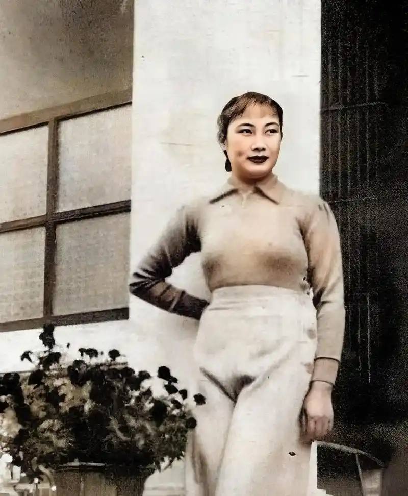 一张20世纪20年代的老照片,民国"女王"胡蝶坐在桥上,靠在栅栏上,看