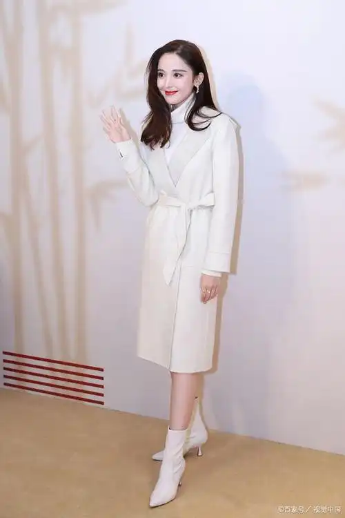 古力娜扎打扮清新脱俗,风衣配上白色的尖头靴更是显得高挑可人