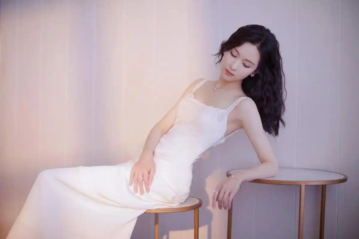 春日暖阳,陈都灵白色蕾丝吊带裙如百合绽放!