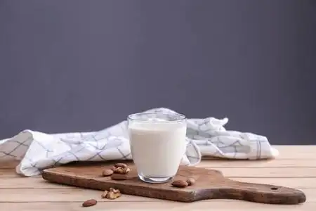 木制桌子上的一杯鲜牛奶照片