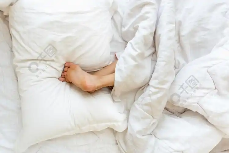 小女孩倒着睡双脚放在枕头上的特写