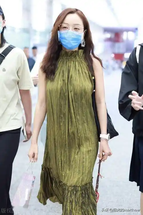 2023年5月31日,北京,杨蓉机场街拍.身穿绿色褶皱无袖挂脖裙随性松弛.