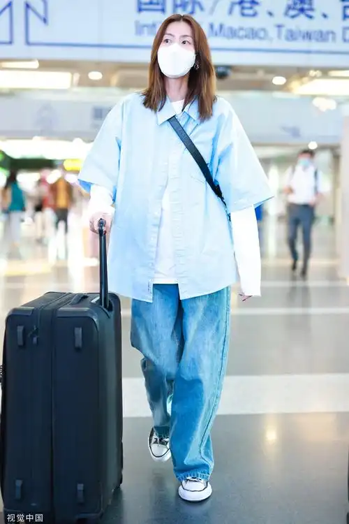刘雯衬衫叠穿造型休闲现身首都机场和粉丝积极互动