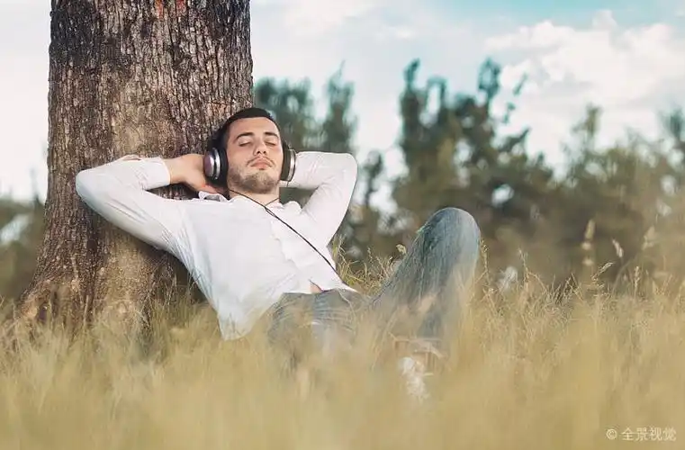 男人_享受_音乐_人_听_祥和_倚靠_树_放松_户外_高清图片_全景视觉