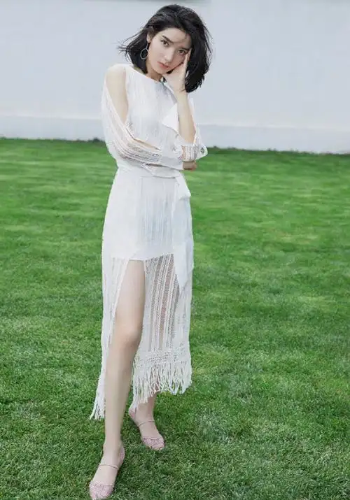 1/ 12 代斯着一袭蕾丝条纹连衣裙悠然的漫步在翠绿之中,那抹白色的