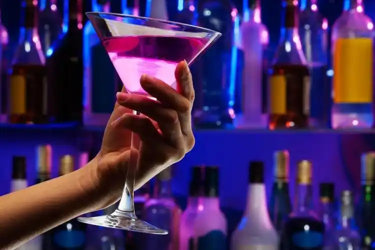 女人手拿鸡尾酒杯