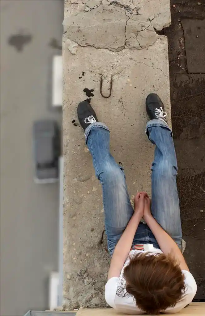 自杀的女孩,女孩坐在屋顶的边缘上