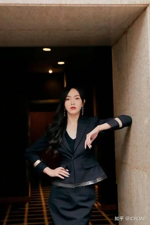 唐嫣身穿一件黑色的短款上衣搭配一条黑色的包臀半身裙上衣的领口和