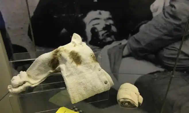 a bandage and a babys vest are pictured at