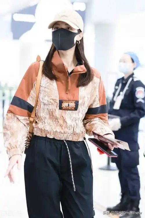 街拍:钟楚曦棕红色花纹套头衫休闲时尚,黑色工装裤显修长身材_机场