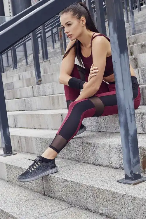 照片 健身运动女性在户外运动锻炼. 坐在楼梯上的漂亮女孩.