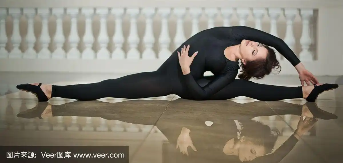 优雅的芭蕾舞演员在大理石地板上做劈叉