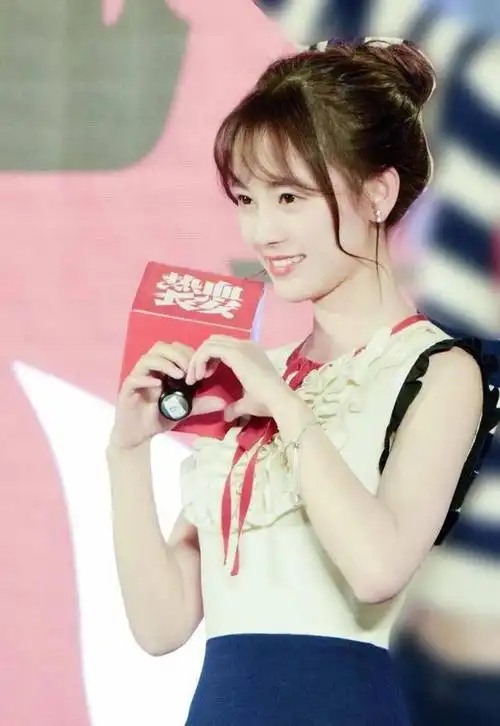 鞠婧祎扎着清新的丸子头造型亮相在舞台上,可爱比心的她非常甜美.