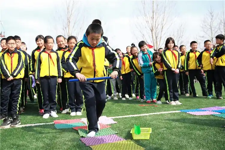 指压板接力赛中,孩子们不仅要踩在指压板上,还要小心翼翼地把手里的