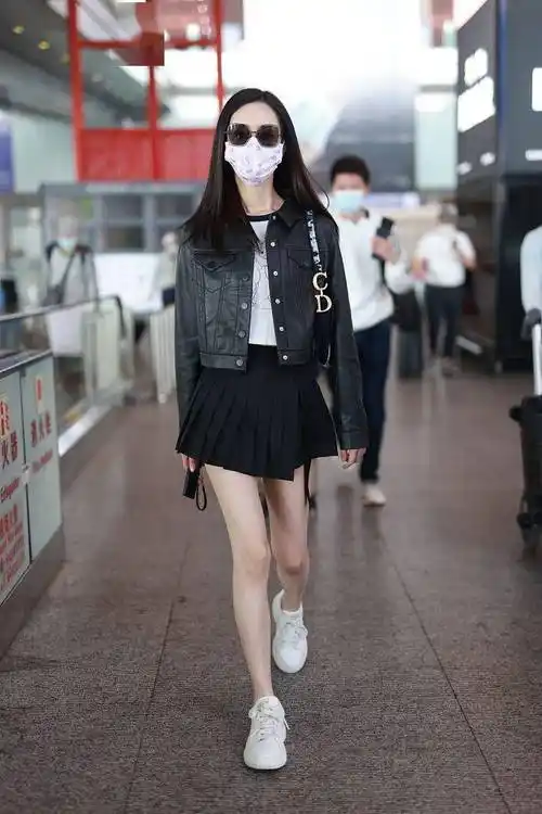 陈都灵首都机场街拍秀美腿黑皮衣搭百褶短裙俏皮时尚
