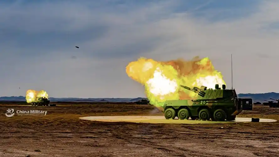 artillerymen practice firing towed howitzers