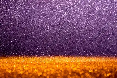 蜜科含有闪亮金和紫色光的简要背景抽象的散质地背景