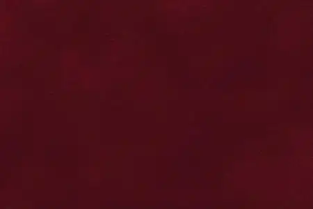 暗红色麂皮绒织物特写的背景.天鹅绒亚光质地的酒磨砂纺织照片