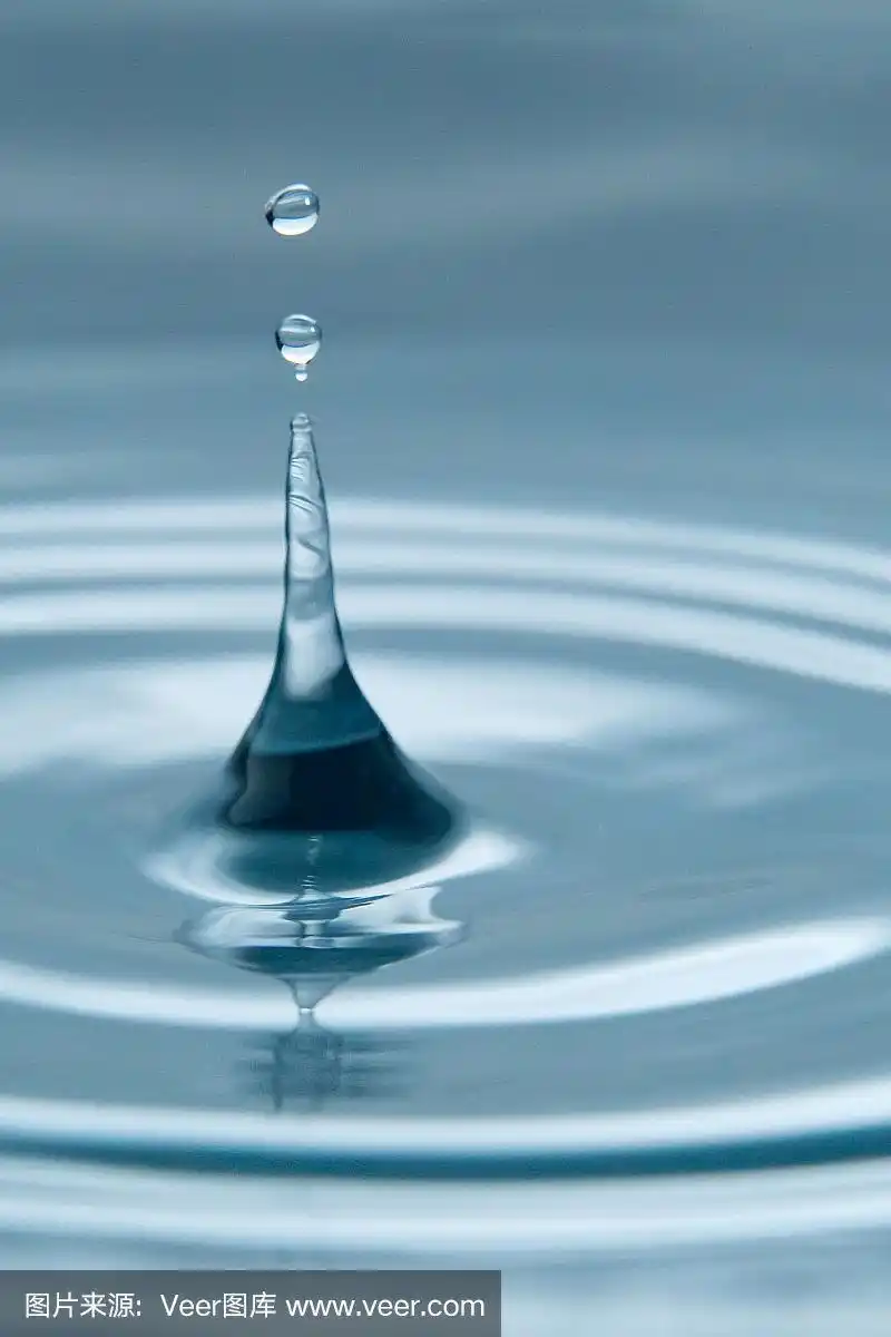 美丽的水滴溅在水面上,微距照片