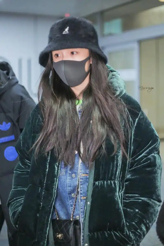 杨幂穿丝绒外套搭配阔腿牛仔裤现身机场,戴黑色渔夫帽和口罩遮面