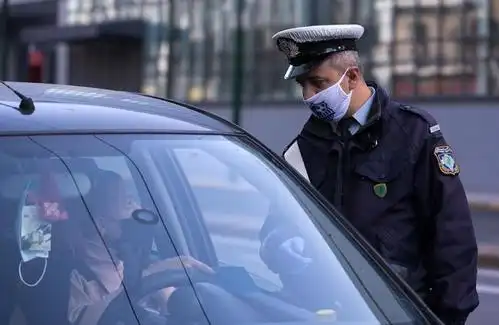 ↑11月7日,在希腊雅典,一名警察拦停车辆检查出行许可.