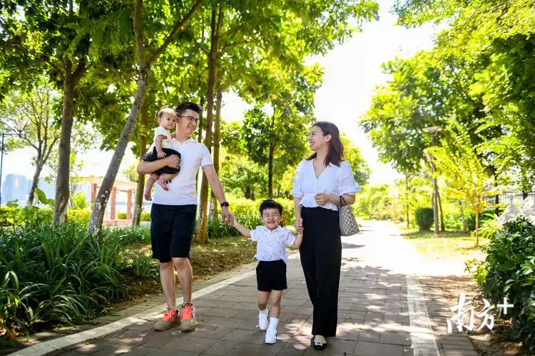 一家四口正在梅江河畔散步,欢声笑语.(南方日报记者 何森垚 摄)