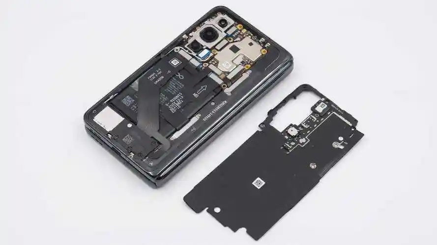 拆开后盖可见手机内部的各个模组均使用螺丝固定,右上方为扬声器,中部