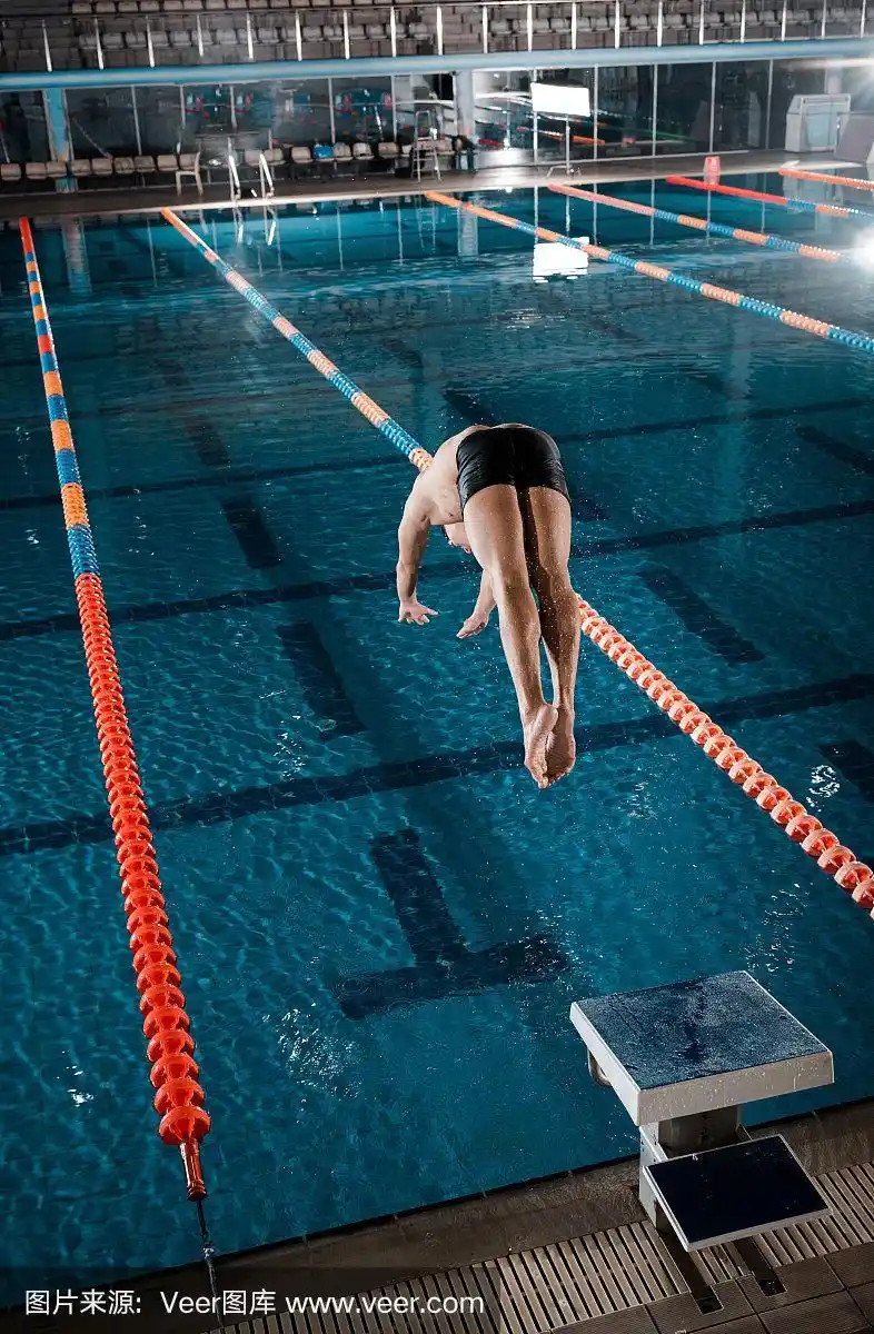 运动员跳入游泳池的水里