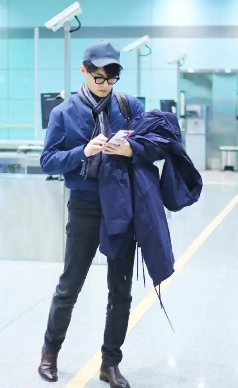 机场照的靳东也有不错的表现,全身蓝色的装扮,深蓝色的外套下搭紧身