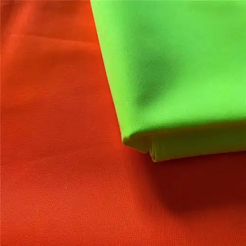 荧光色经编平布交通提醒布料现货批发一卷25公斤可定制加工荧黄橙