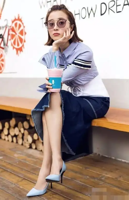 牛仔裙的胡冰卿看起来颇为时髦,特别是她在脚上穿了一双蓝色高跟鞋,更