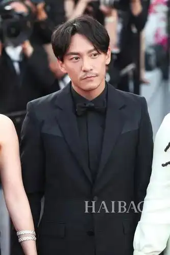 首次做戛纳评委的张震身着剪裁合身的全黑西服套装,搭配中分发型与乱