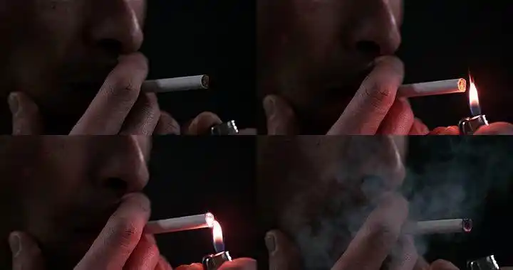 在黑色背景下抽烟的男人