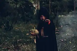 i>女 /i> i>鬼 /i>恐怖她手上拿着南瓜,有魔杖,万圣节概念