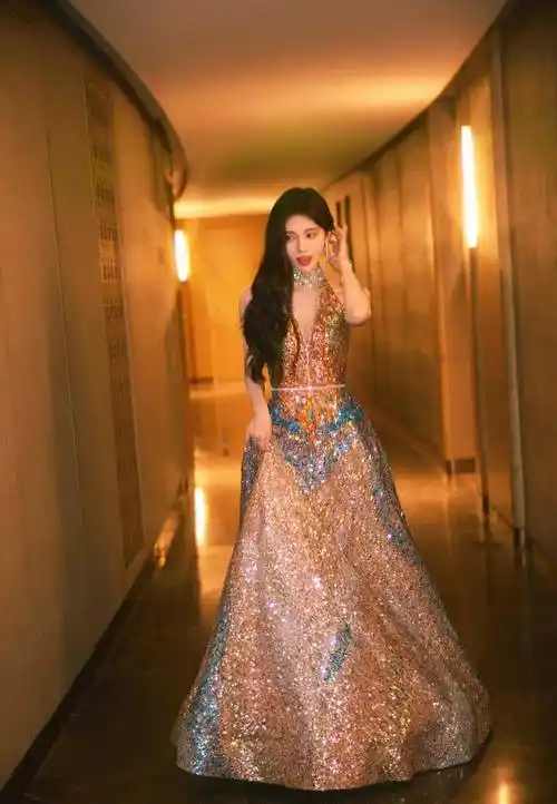 鞠婧祎出席东方风云榜音乐盛典红毯造型曝光,一袭金色流彩晚礼服,深v