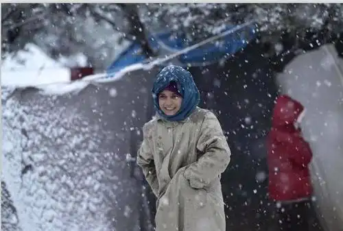 一个赤脚在雪地里气哭泣的叙利亚儿童