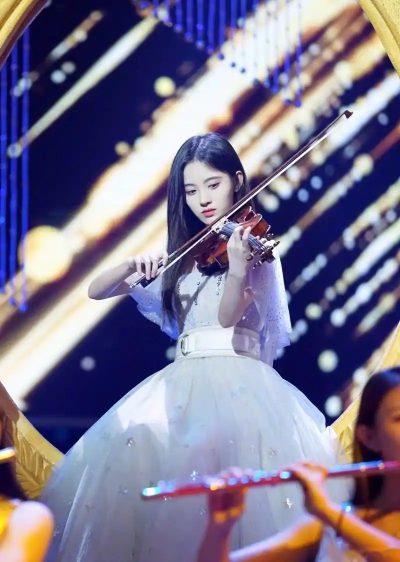 鞠婧祎晒出自拍和在舞台上拉小提琴的照片,并感慨:"上学的时候拉琴