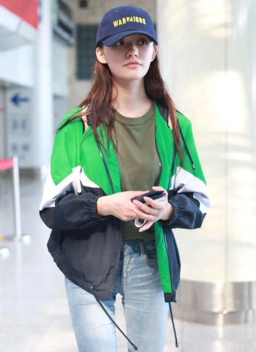 林允头戴深蓝色棒球帽现身机场 伸舌咬嘴卖萌可爱满分