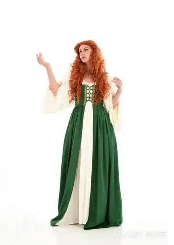 全长肖像红头发的女孩身穿绿色中世纪礼服, 站立姿势.