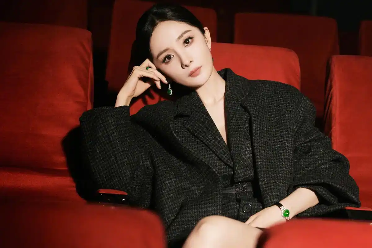 杨幂穿着黑色长外套和高跟鞋,头发向后梳,展现高冷造型的魅力!