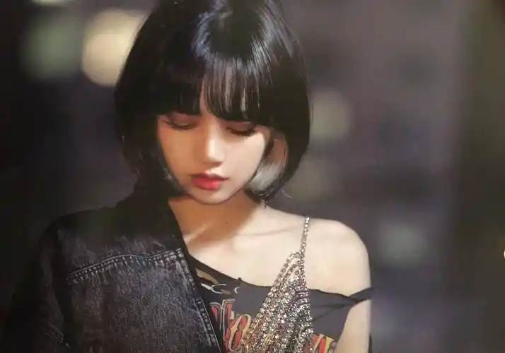 照片以黑白色为主调,lisa头戴一顶棒球帽,齐肩的短发随意披散着,身穿