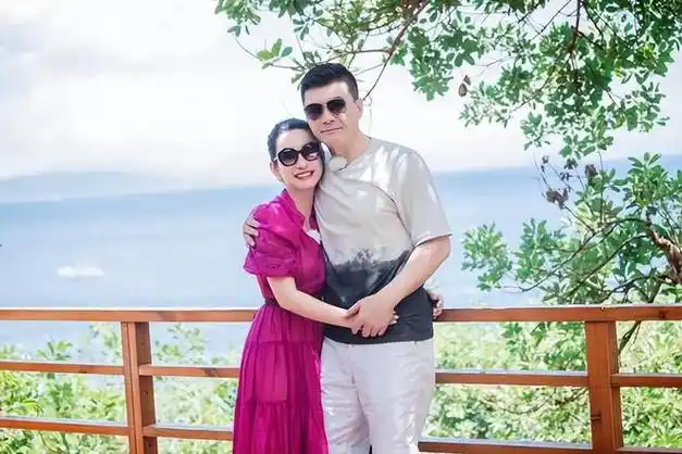 秦海璐越活越年轻!44岁穿玫红裙如大学生,躲老公怀中娇羞似少女