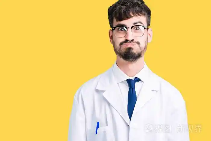 年轻的职业科学家,穿着白色外套,在孤立的背景上,鼓着脸颊,脸上带着