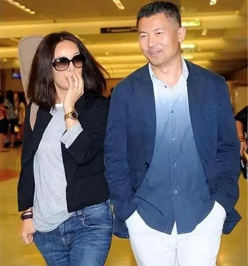 那英跟同岁老公走机场似父女一个嫩成女儿辈一个似中年老头